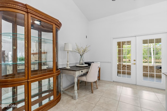 office space featuring french doors, lofted ceiling, and light tile patterned flooring