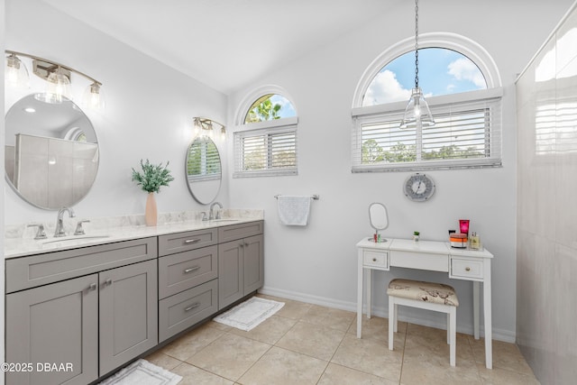 bathroom featuring tile patterned floors, vanity, and vaulted ceiling