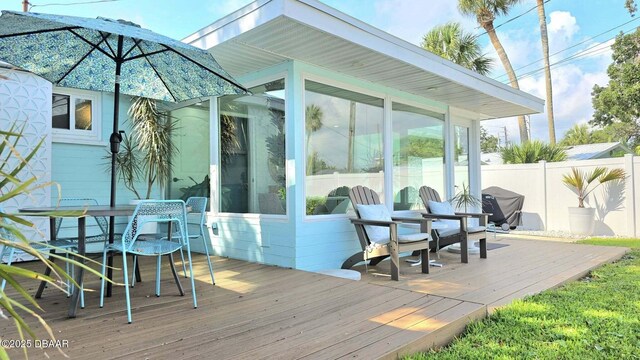 70 Ocean Shore Dr, Ormond Beach, FL 32176 - deck featuring a sunroom