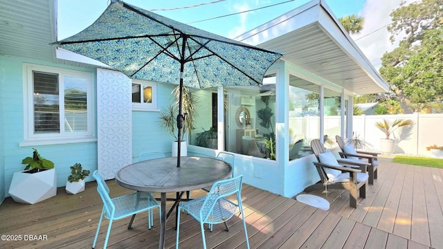 70 Ocean Shore Dr, Ormond Beach, FL 32176 - deck featuring a sunroom and outdoor dining area