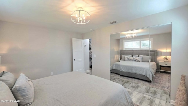 70 Ocean Shore Dr, Ormond Beach, FL 32176 - bedroom featuring a chandelier and wood finished floors