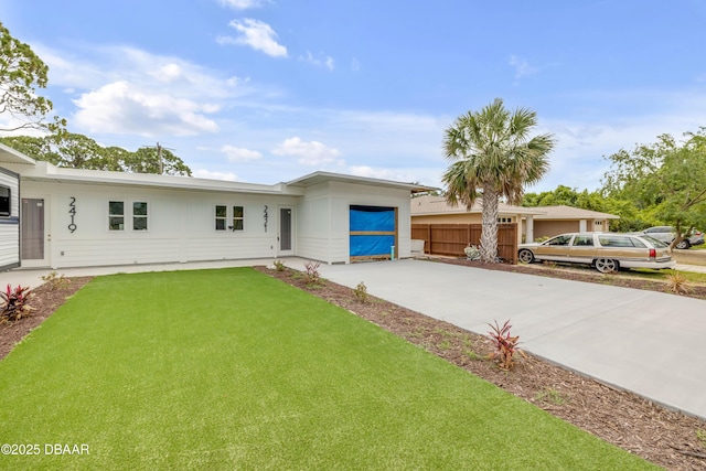 2419 India Palm Dr, Edgewater, FL 32141 - view of front of house featuring driveway, a front yard, and fence