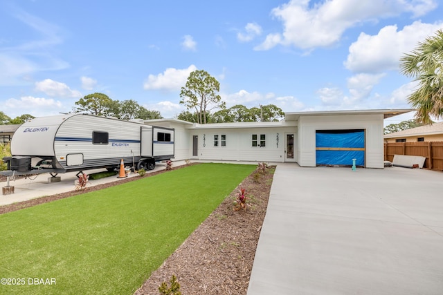 2419 India Palm Dr, Edgewater, FL 32141 - view of front facade featuring concrete driveway, a front yard, and fence