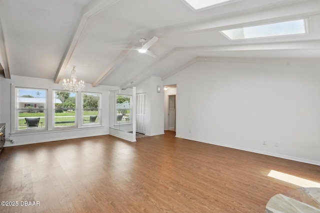 88 Cindy Ln, Ponce Inlet, FL 32127 - unfurnished living room with a skylight, a chandelier, wood finished floors, ceiling fan, and baseboards