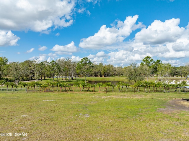 view of yard with a rural view and fence