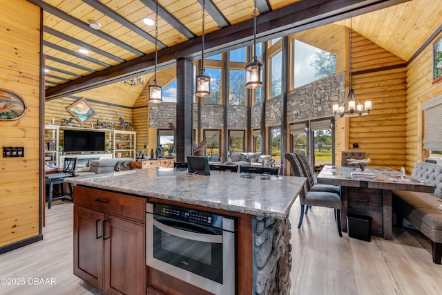 kitchen featuring wooden ceiling, open floor plan, and oven