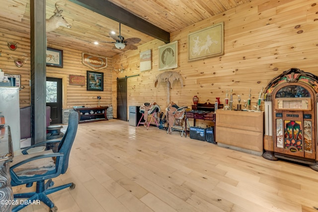 office space with a barn door, wooden ceiling, wood finished floors, beamed ceiling, and rustic walls