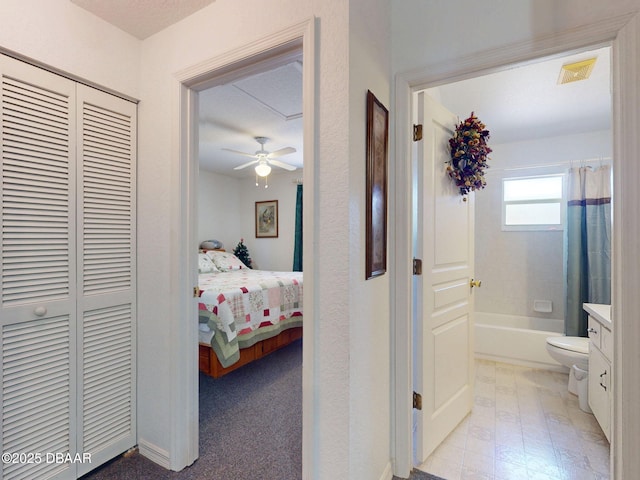 hall featuring visible vents and baseboards