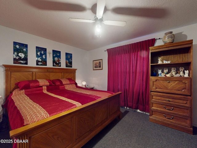 bedroom with a ceiling fan and dark carpet