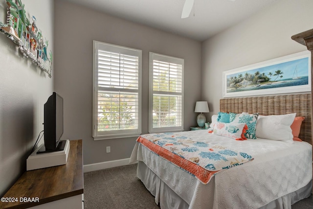 bedroom featuring ceiling fan and dark carpet