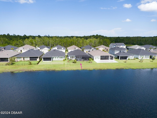 birds eye view of property with a water view