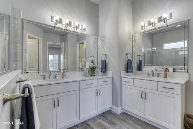 bathroom featuring walk in shower, vanity, hardwood / wood-style flooring, and a wealth of natural light