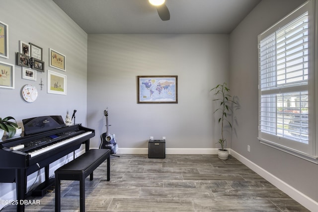 misc room with hardwood / wood-style floors and ceiling fan