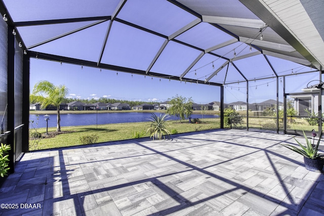 view of patio / terrace with a water view and a lanai