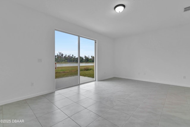 empty room featuring visible vents and baseboards