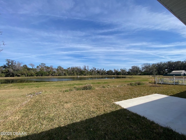 view of yard with a patio and a water view