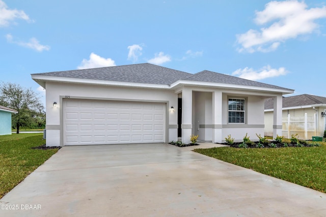 view of front facade featuring a garage, a front yard, concrete driveway, and stucco siding