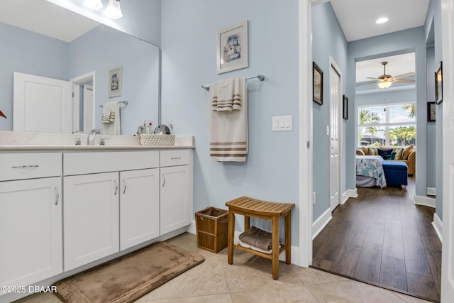 bathroom with ceiling fan, tile patterned flooring, and vanity