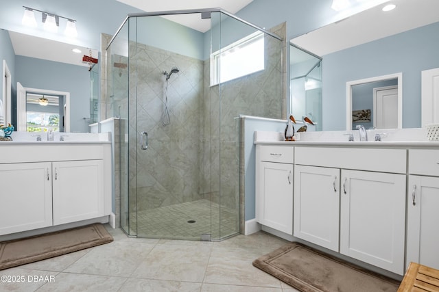 bathroom featuring ceiling fan, vanity, and an enclosed shower