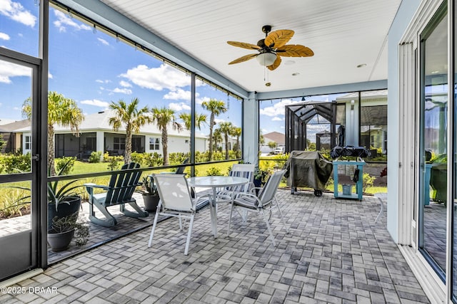 sunroom / solarium with ceiling fan