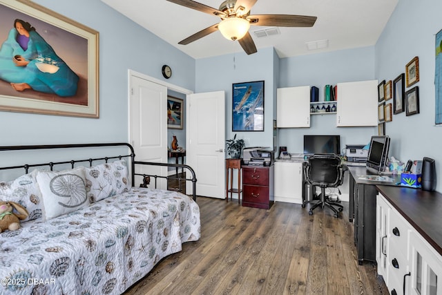 bedroom with ceiling fan and dark wood-type flooring