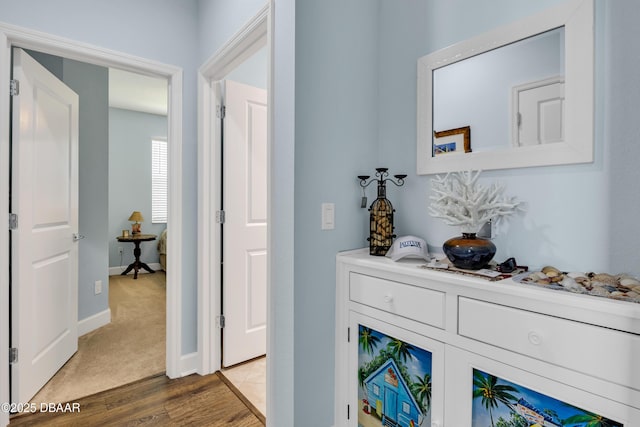 corridor with hardwood / wood-style flooring