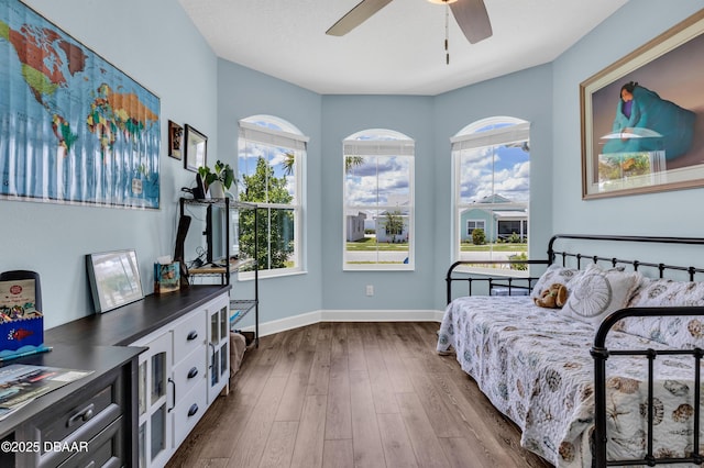 bedroom with ceiling fan and hardwood / wood-style flooring