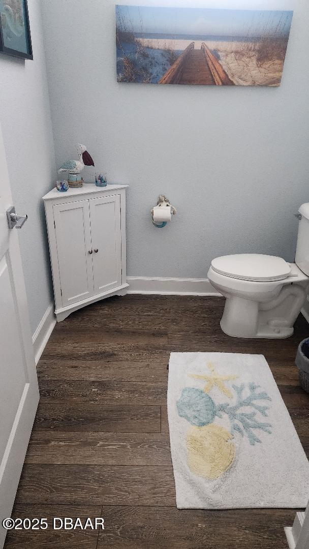 bathroom featuring wood-type flooring and toilet