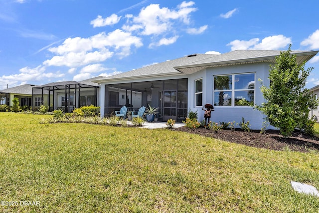 rear view of property with a sunroom and a yard