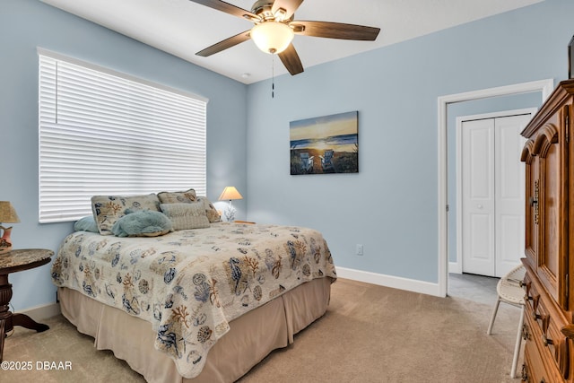 bedroom with light colored carpet, a closet, and ceiling fan