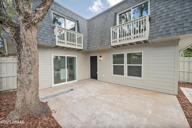 rear view of house featuring a patio area and a balcony