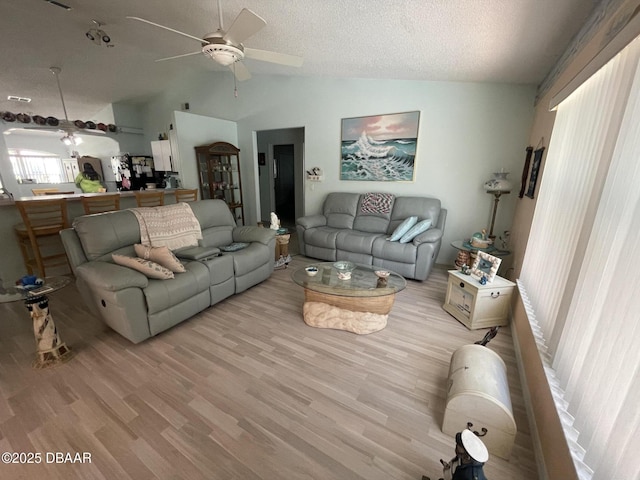 6037 Hickory Grove Ln, Port Orange, FL 32128 - living room with lofted ceiling, a ceiling fan, wood finished floors, and a textured ceiling