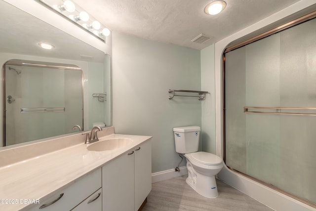 full bath with vanity, wood finished floors, toilet, baseboards, and a shower stall
