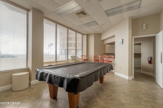 playroom with a paneled ceiling, baseboards, and a healthy amount of sunlight