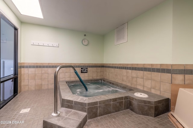 bathroom with tile patterned floors and tile walls