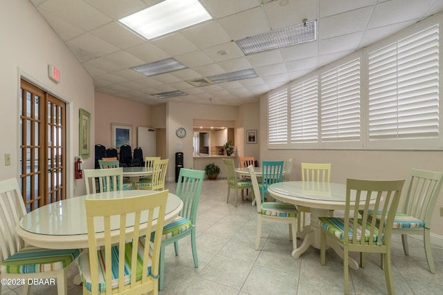 dining room featuring light tile patterned floors, a drop ceiling, and visible vents
