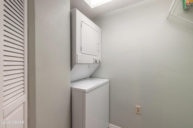washroom with laundry area and stacked washer / dryer