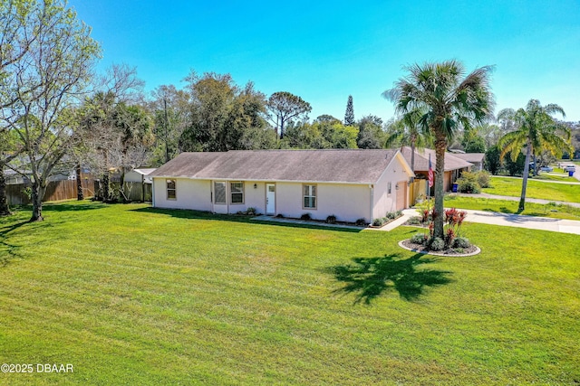 ranch-style house with stucco siding, concrete driveway, a front yard, fence, and a garage