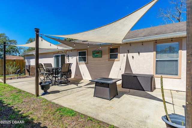 view of patio featuring an outdoor fire pit, fence, and outdoor dining space