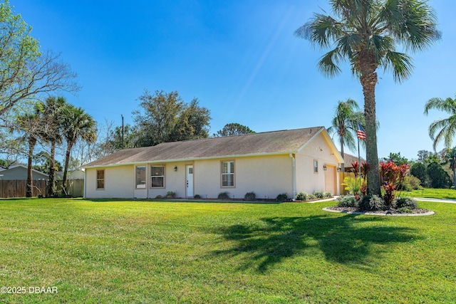 ranch-style house with a front yard, fence, an attached garage, and stucco siding