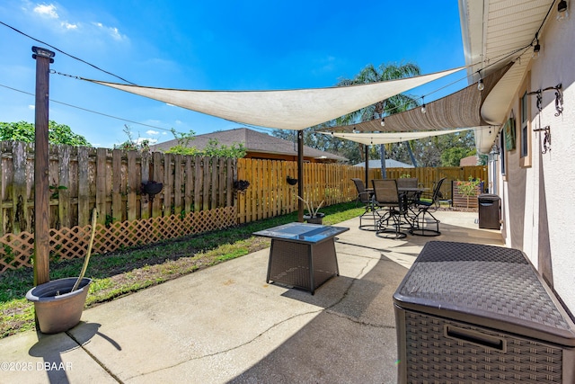 view of patio with outdoor dining area and a fenced backyard