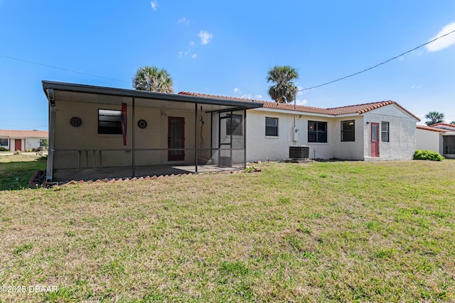 rear view of house with a patio area and a lawn