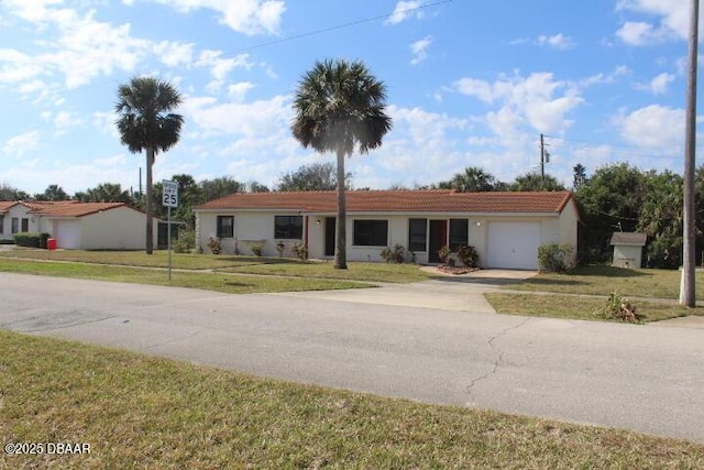 ranch-style home with a garage and a front lawn