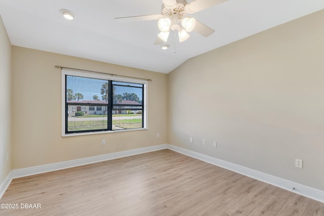 empty room featuring lofted ceiling, ceiling fan, and light wood-type flooring