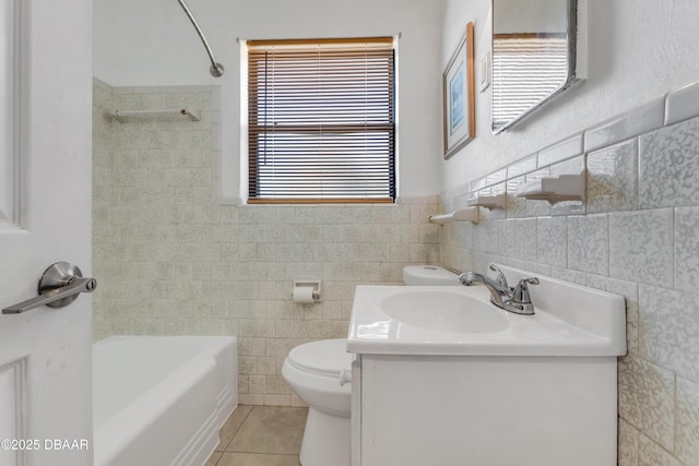 full bathroom featuring shower / bathing tub combination, tile walls, vanity, toilet, and tile patterned floors