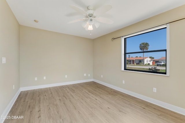 empty room with ceiling fan and light wood-type flooring