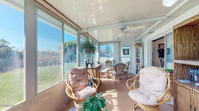 sunroom featuring ceiling fan and a healthy amount of sunlight