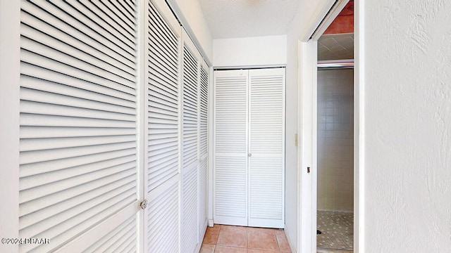 hall featuring light tile patterned floors