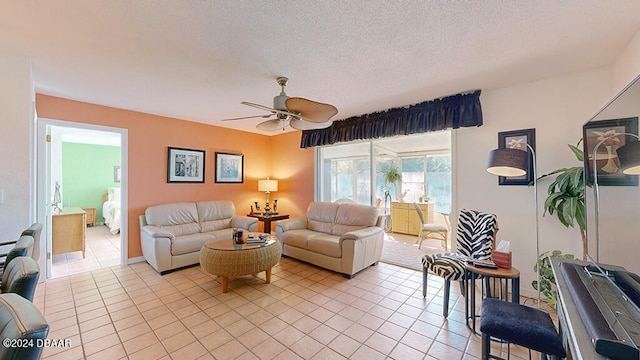 living room featuring a textured ceiling, light tile patterned flooring, and ceiling fan