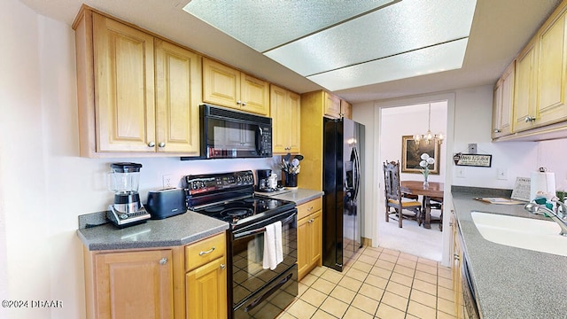 kitchen featuring sink, black appliances, light brown cabinetry, light tile patterned floors, and an inviting chandelier